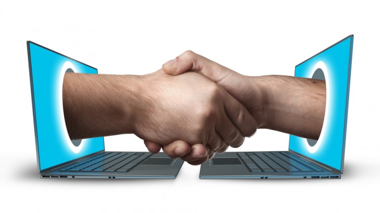 Image of a smart-contract, two computers handshaking